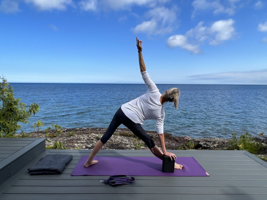 Subject performing yoga pose by lake